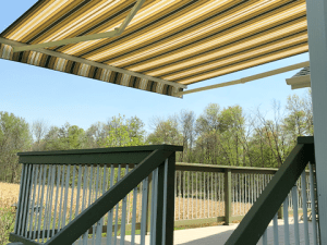 An open awning provides state-of-the-art shade on a backyard deck