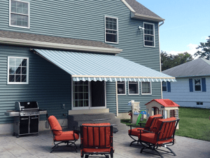 A Midwestern home patio is shaded comfortably by a Sunesta awning