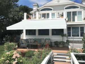 A Sunesta awning with revolutionary technology is extended over a patio in the Southwest